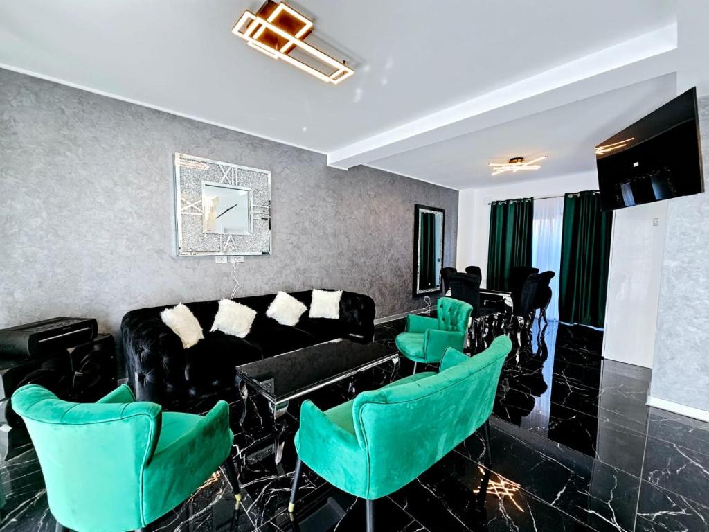 a living room with green chairs and a couch at Luxury Private Villa in Tunari