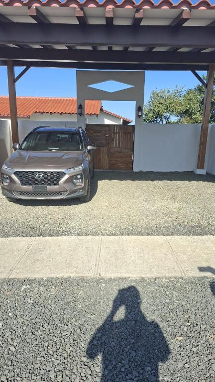 a shadow of a car parked in front of a house at Farmer's house in El Quije