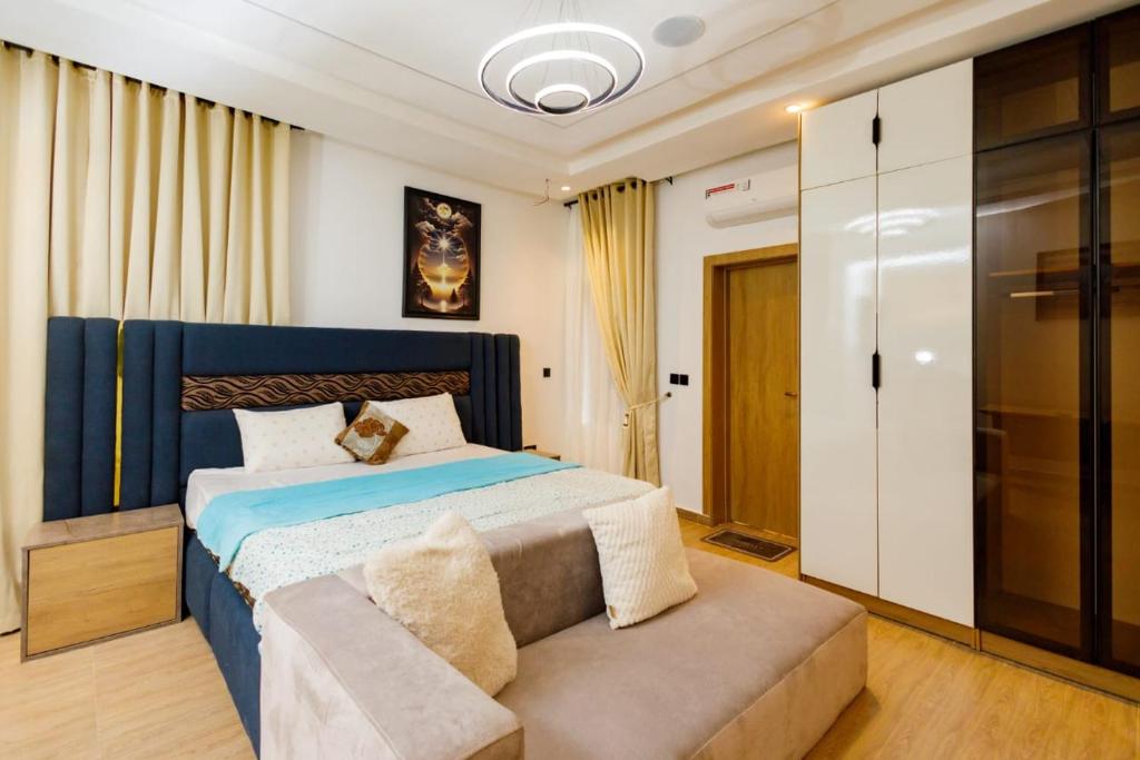 a bedroom with a large bed and a couch at Studio Room by Elegushi beach resort in Mama
