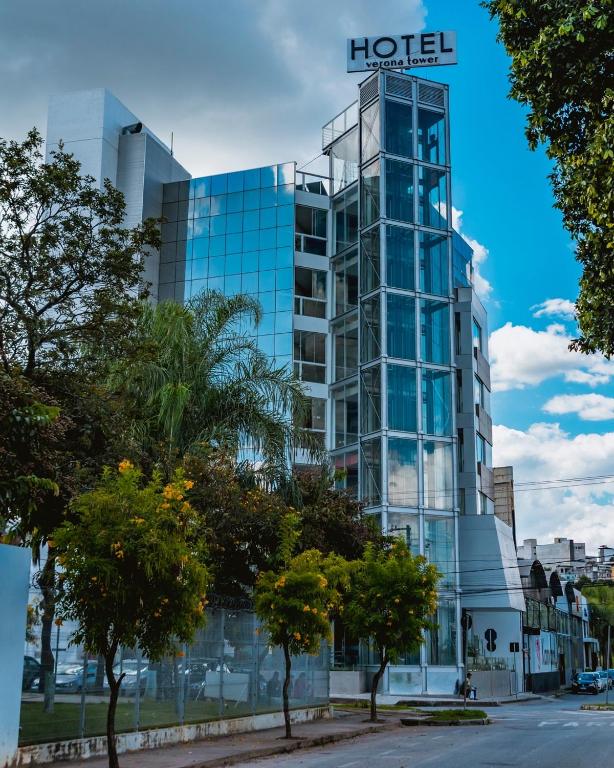 a tall glass building with a hotel sign on it at Verona Tower Hotel in Divinópolis