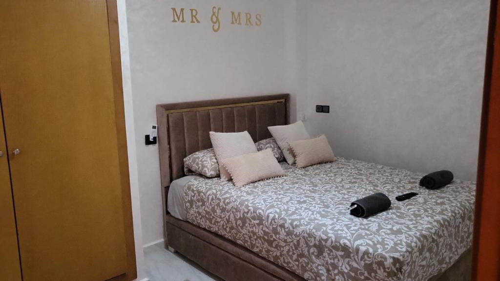 ein Schlafzimmer mit einem Bett mit zwei Hüten darauf in der Unterkunft Mini villa trougout in Al Hoceïma