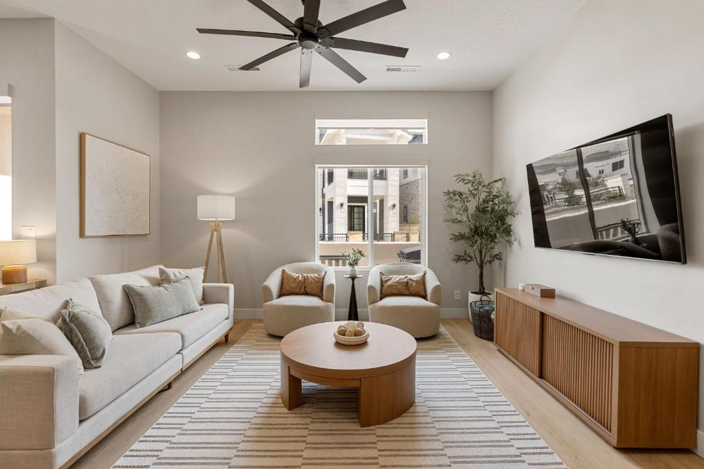 a living room with a couch and a tv at Weekend Vibes townhouse in St. George