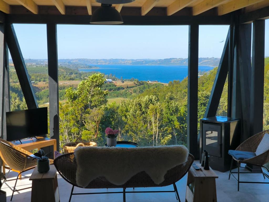 a living room with a view of the water at Casa Esquila de Chiloé in Chonchi