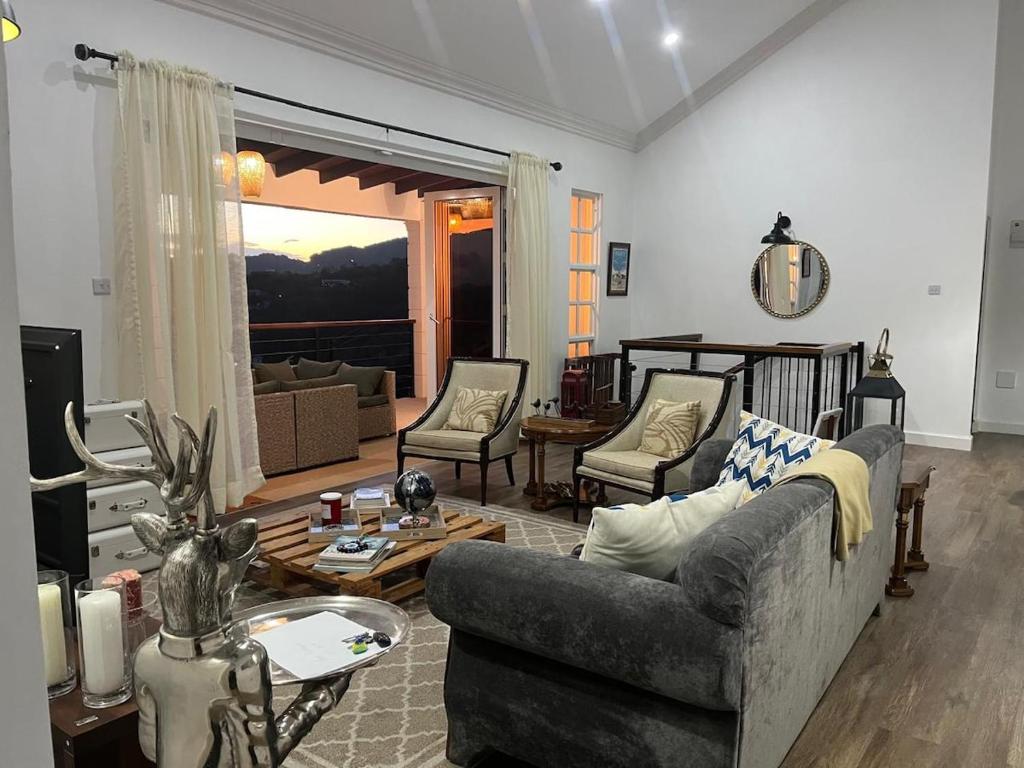 a living room with a couch and a table at The House Next Door in Calliaqua