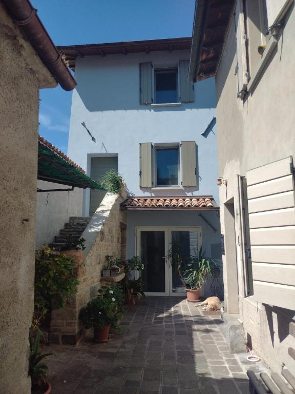 a white house with a cat sleeping in the courtyard at Casina Borgo Castello in Civitella di Romagna