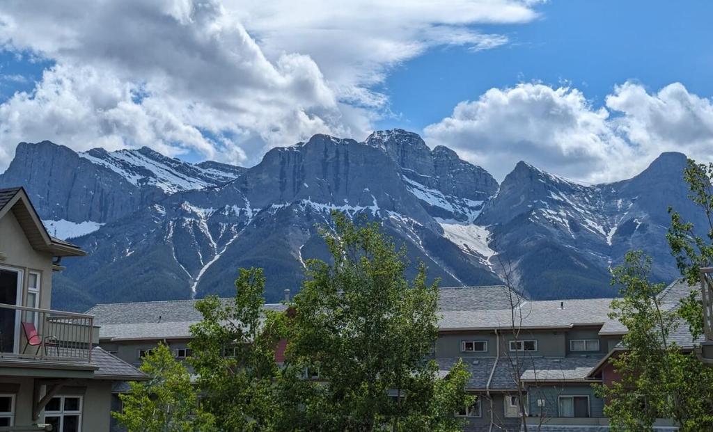a view of a mountain range with houses and trees at 2 Bedroom Condo Banff, Canmore sleeps 6 comfortably in Canmore