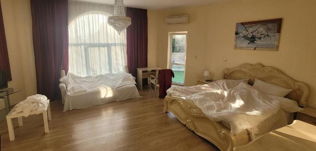 a bedroom with two beds and a large window at Testamber in Varna City