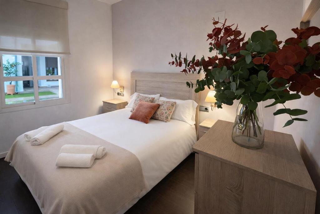 En eller flere senge i et værelse på Casa de las Flores