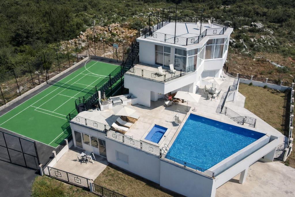 an aerial view of a house with a tennis court at Villa Redzic Residence in Brca