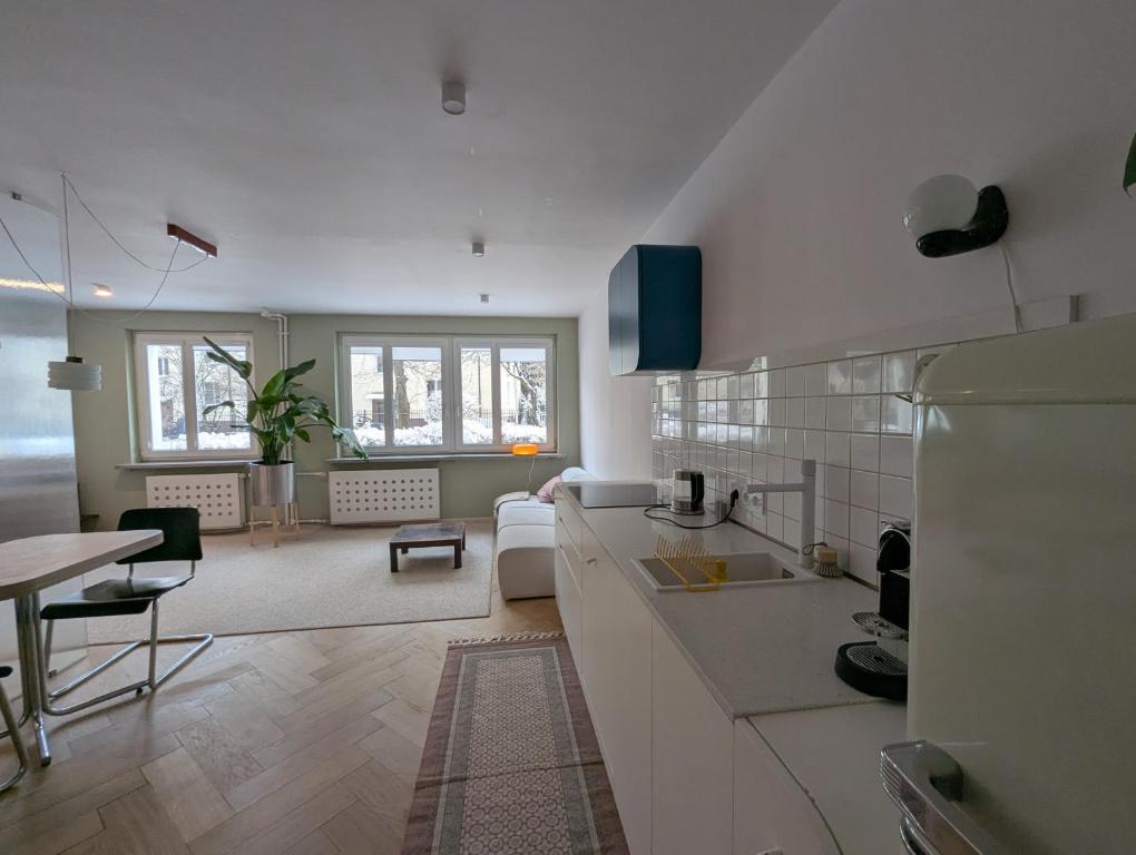 a kitchen and living room with a couch and a table at Rakietników vintage condo in Warsaw