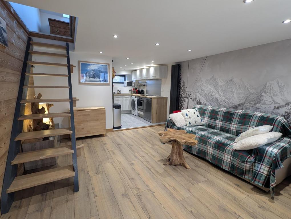 a living room with a couch and a staircase at Maisonnette cosy montagne in La Garde