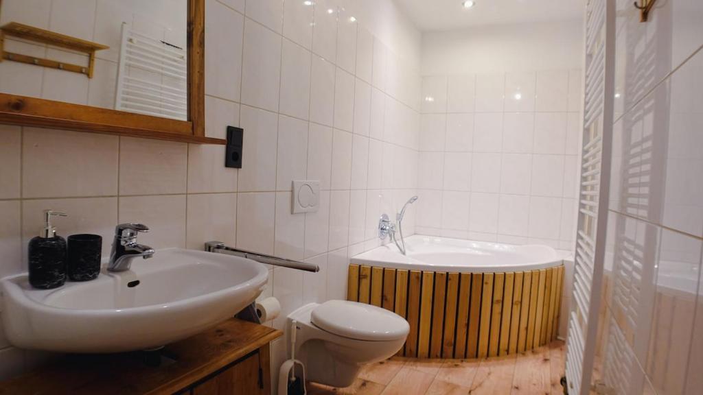 a bathroom with a sink and a toilet and a tub at DoubleRoom - work and stay - shared house - 2floor in Linz am Rhein