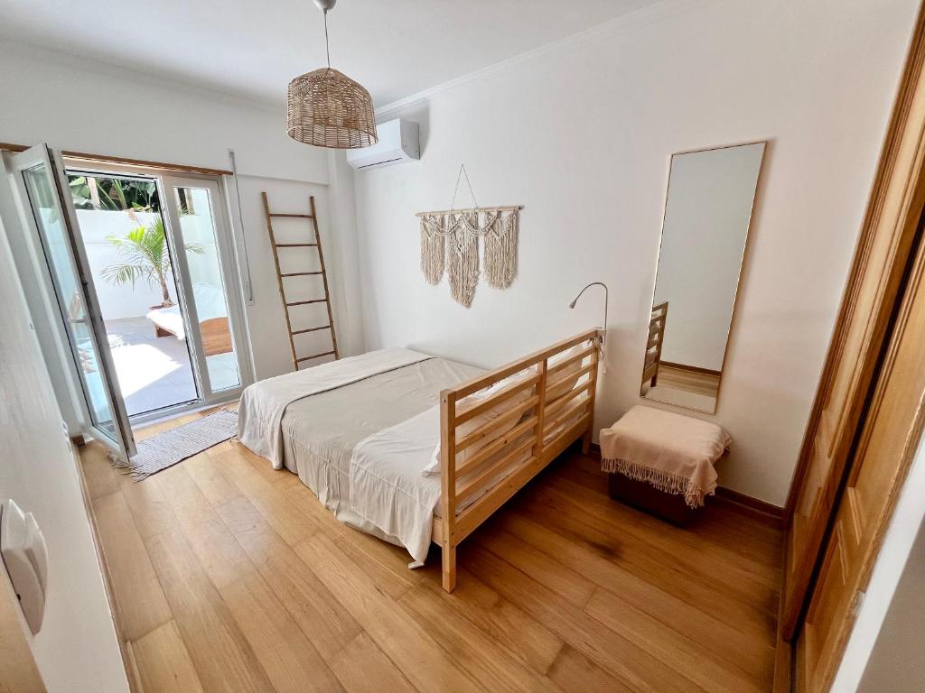 een slaapkamer met een bed en een spiegel bij Miguel Surf House in Costa da Caparica