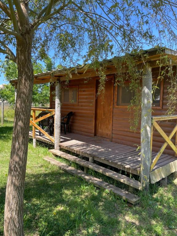 a wooden cabin with stairs leading to a porch at Cabaña 4 in Necochea