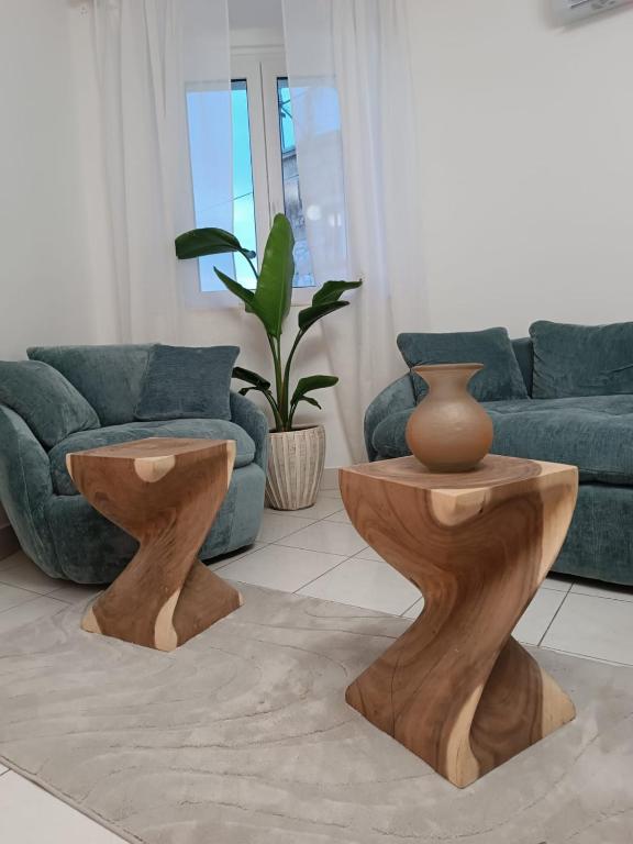 a living room with two wooden tables and a couch at Paulla in Šibenik