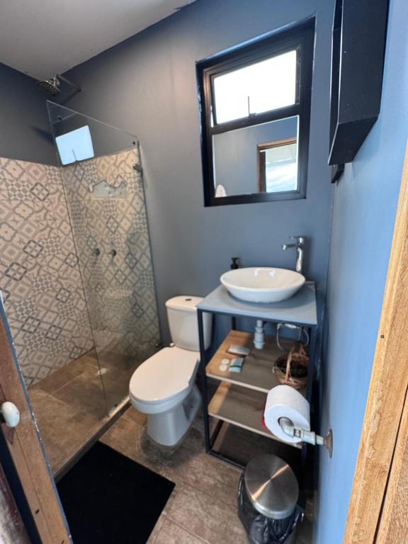 een badkamer met een toilet, een wastafel en een spiegel bij Minicasas La Villa in Santa Sofía