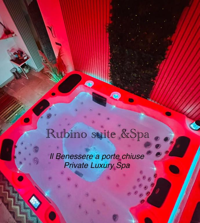 a hot tub in a room with a sign on it at Rubino Private SPA & Room in Corato