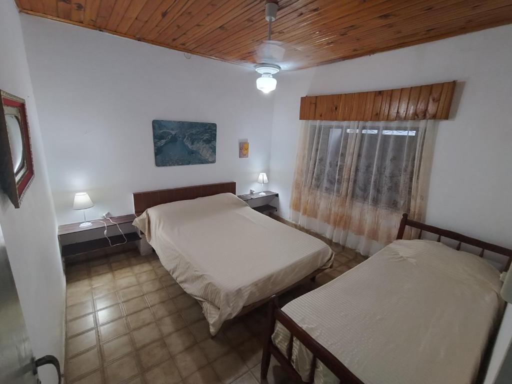 een slaapkamer met twee bedden en een raam erin bij Ziegler House in Concepción del Uruguay