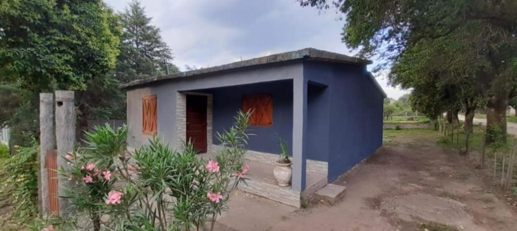 a small blue shed with a vase in front of it at El Tito Alojamiento in San Roque