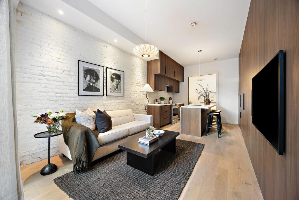 a living room with a couch and a tv at The Brick Hotel - The Second Suite in Toronto