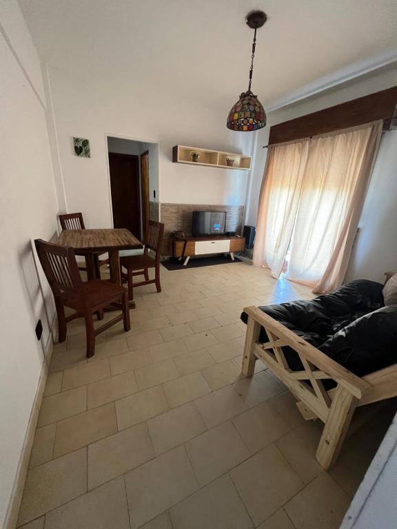 a living room with a couch and a table at Polimar in Mar de Ajó