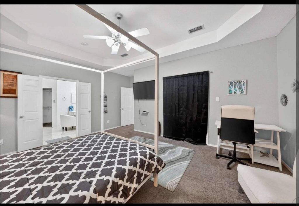 a bedroom with a bed and a desk and a television at Le Monye in Lewisville