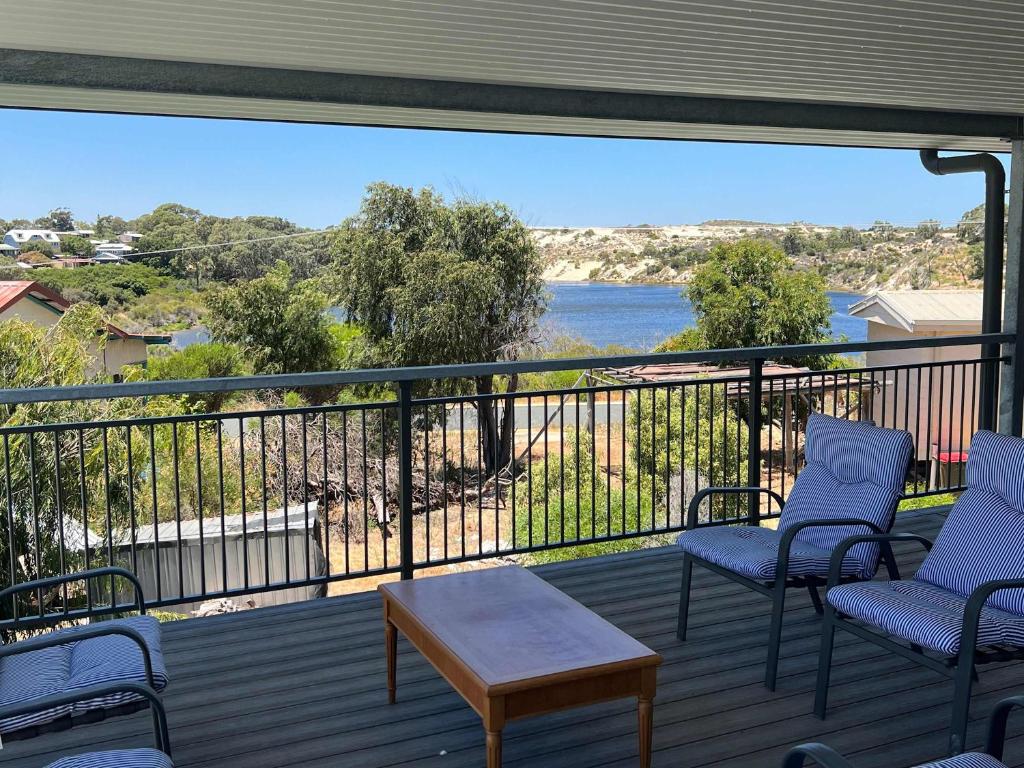 a balcony with chairs and a view of a river at Moore Memories Beach House in Guilderton