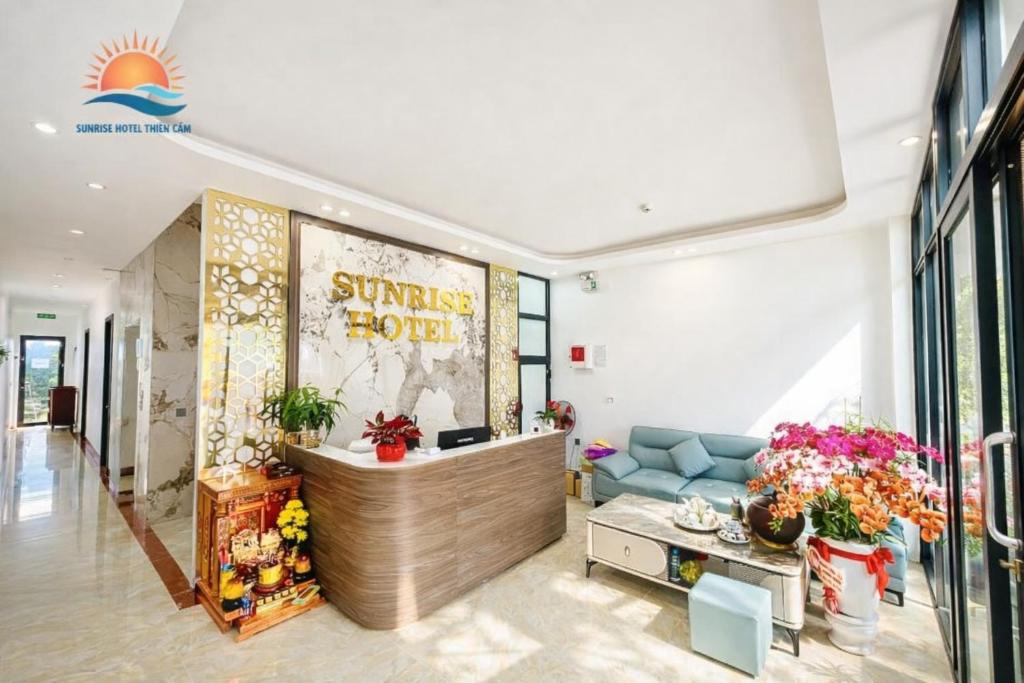 a lobby of a sunoco store with flowers and a couch at Sunrise Hotel Thiên Cầm in Ha Tinh