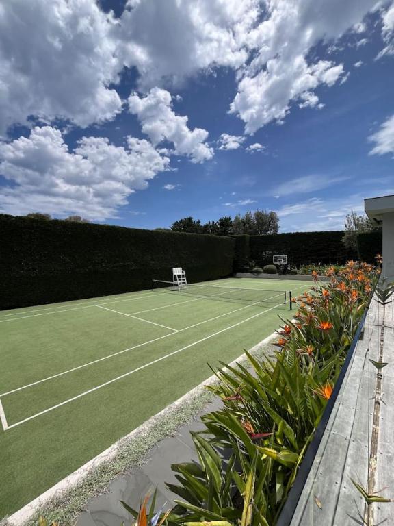 a tennis court with a net on top of it at Portsea Paramount - When only the best will do in Portsea