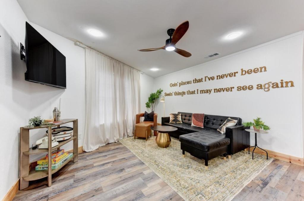 a living room with a couch and a flat screen tv at Independence Bungalow in Wimberley
