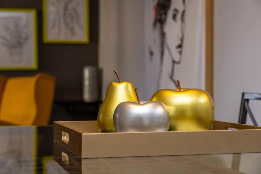 three green and silver apples in a box on a table at Stylish DT Condo ~2 Blocks from Stampede Grounds in Calgary