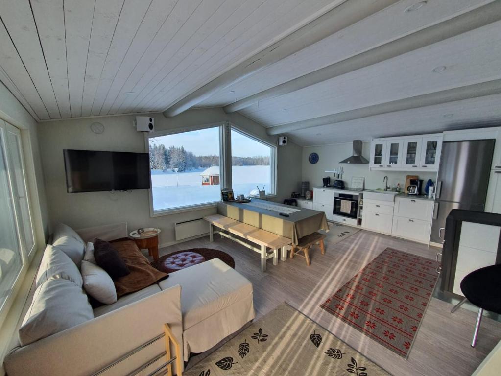 a living room with a couch and a table at Saagala Village in Tornio