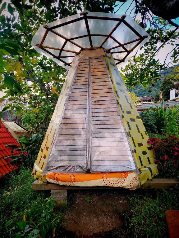 a slide in the middle of a garden at Tipi Miramelinda in Baños