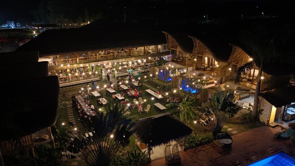 an aerial view of a restaurant at night with lights at Reca Resort and Spa in Porac