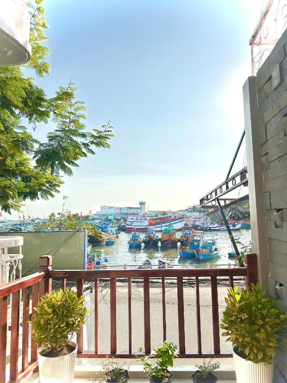 a balcony with a view of a river with boats at Ovana Homestay in Phan Thiet