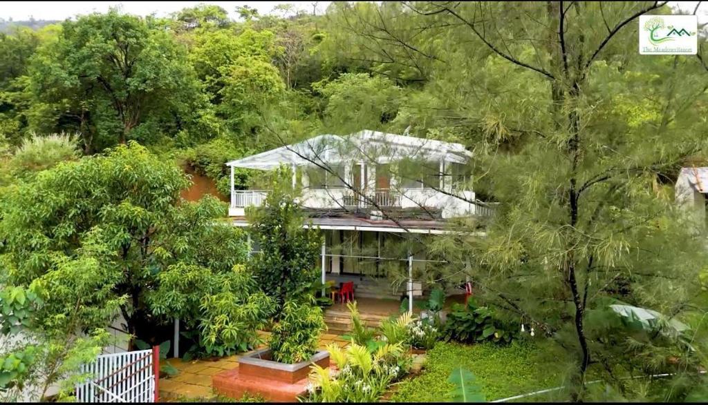 an aerial view of a house in the forest at The Meadows Resort 