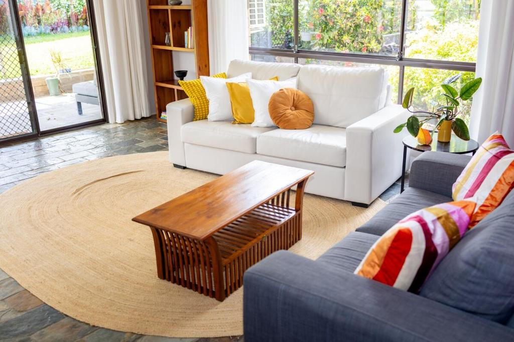 a living room with a couch and a coffee table at Exclusive Living for Professionals in Seacliff