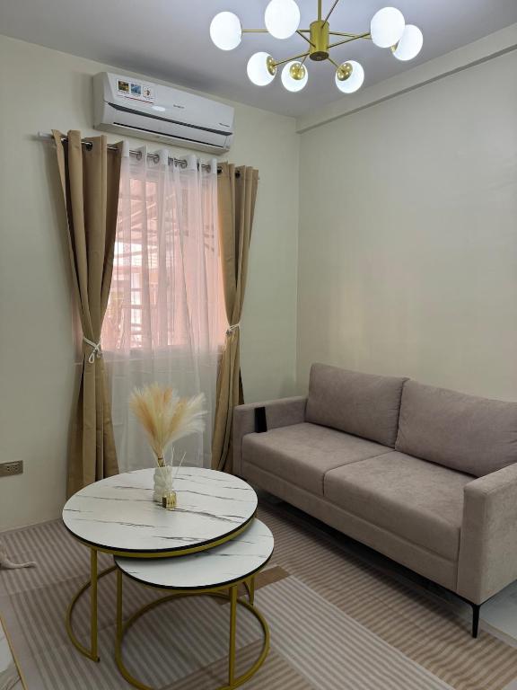 a living room with a couch and a table at BLJ Homes in Angatan