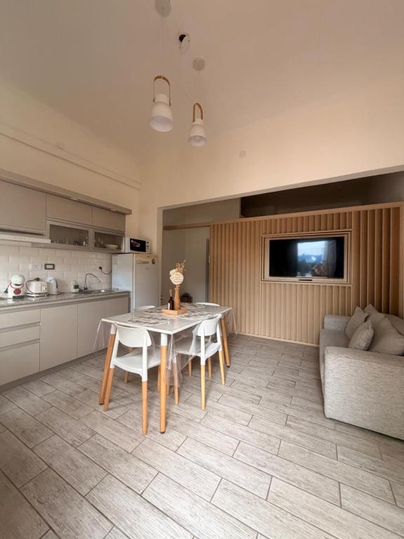 a kitchen and living room with a table and a couch at Martita House in Clorinda