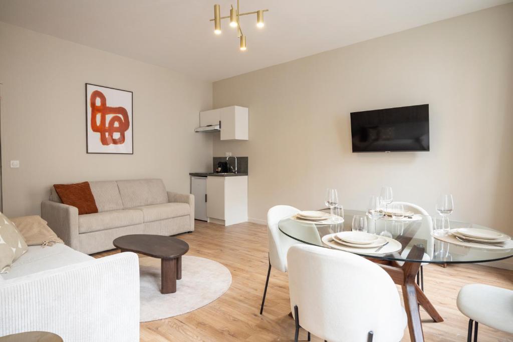 a dining room and living room with a table and chairs at Elegant, fully-equipped, air-conditioned accommodation in Le Pré-Saint-Gervais
