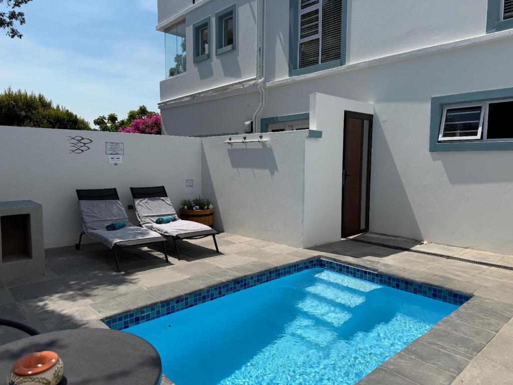 a small swimming pool in front of a house at Ocean Whisper in Plettenberg Bay