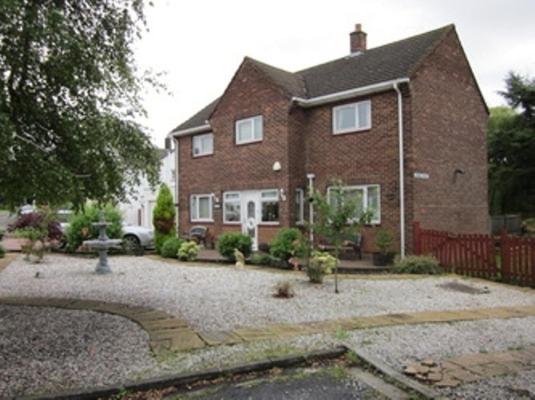 a brick house with a driveway in front of it at Three Bridges Bed & Breakfast in Rosyth