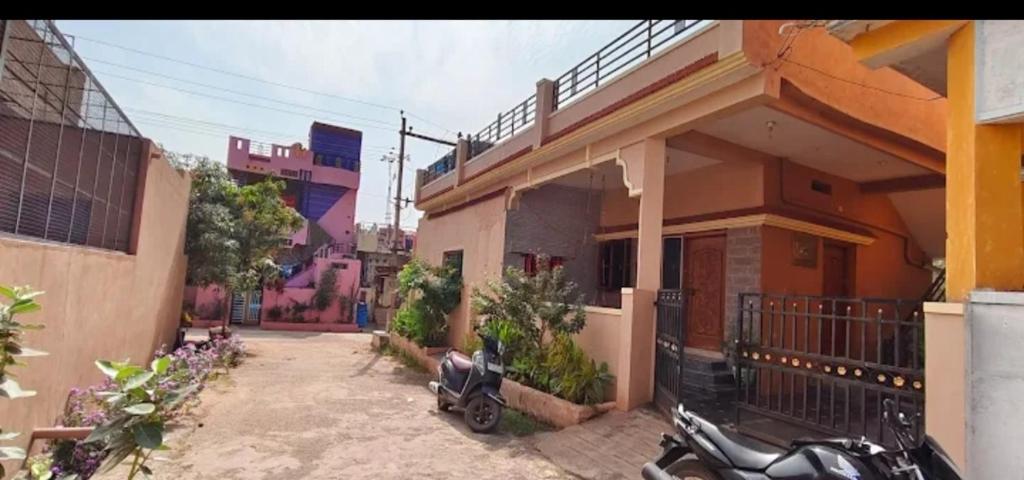 a motorcycle parked in front of a house at M R ViLLA HAMPI magic rock villa in Hampi