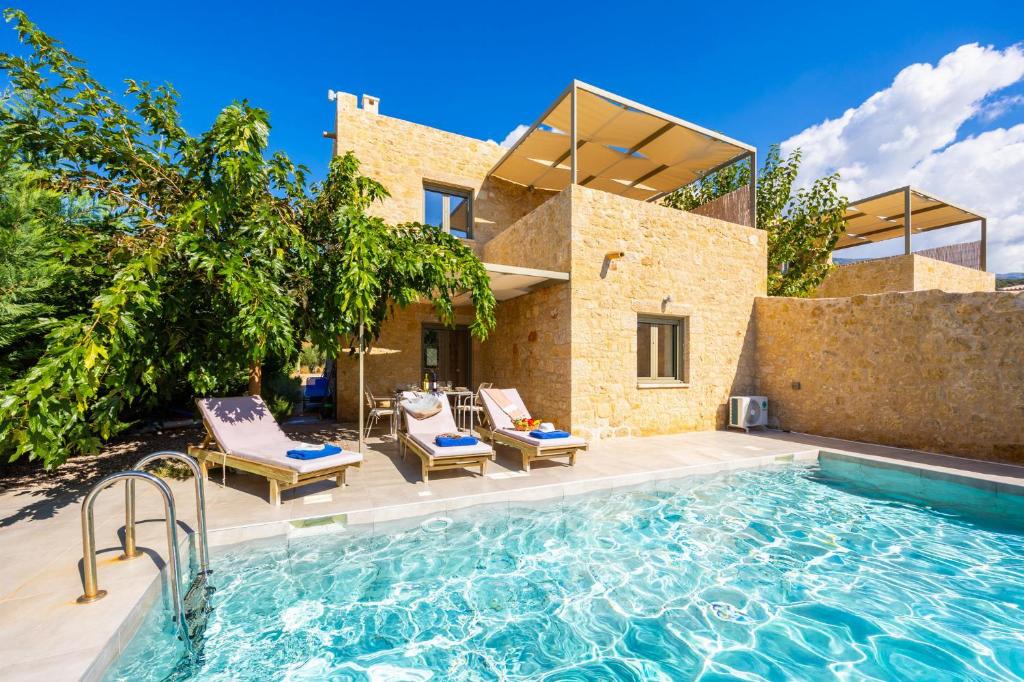 a villa with a swimming pool and a house at Villa Castillo Ena in Agios Nikolaos