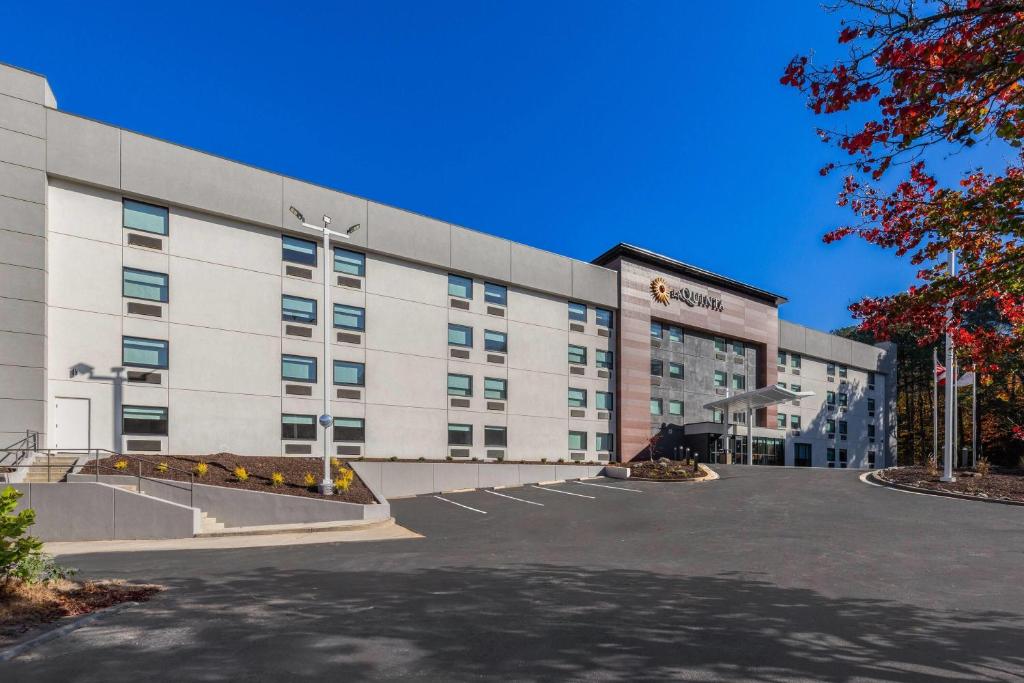 a large building with a parking lot in front of it at La Quinta by Wyndham Atlanta Roswell in Roswell
