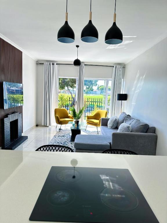 a living room with a couch and a table at Lux City Haven in Cape Town
