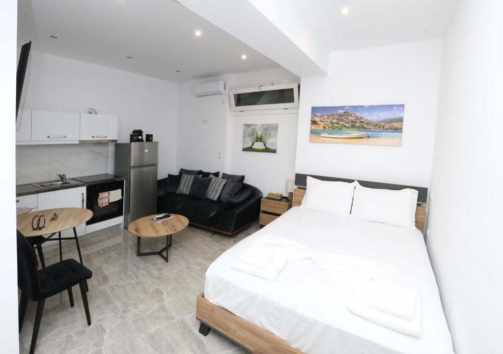 a bedroom with a bed and a living room at Emily Apartments 2 in Chrysoupolis