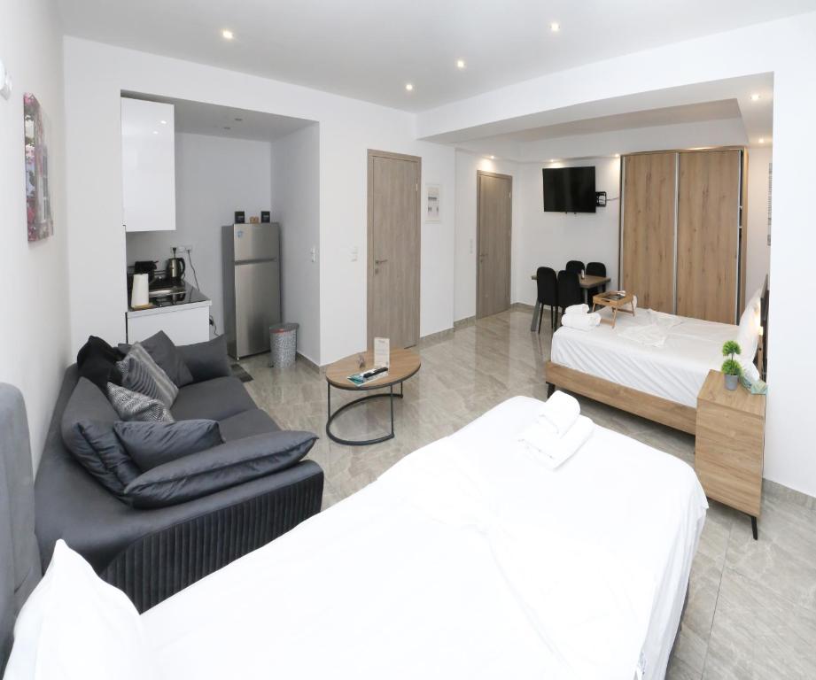 a living room with a couch and a bed at Emily Apartments 3 in Chrysoupolis