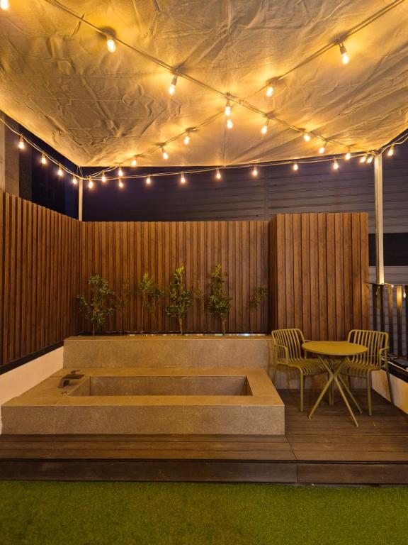 a room with a bench and a table and lights at 루아호텔 in Seoul