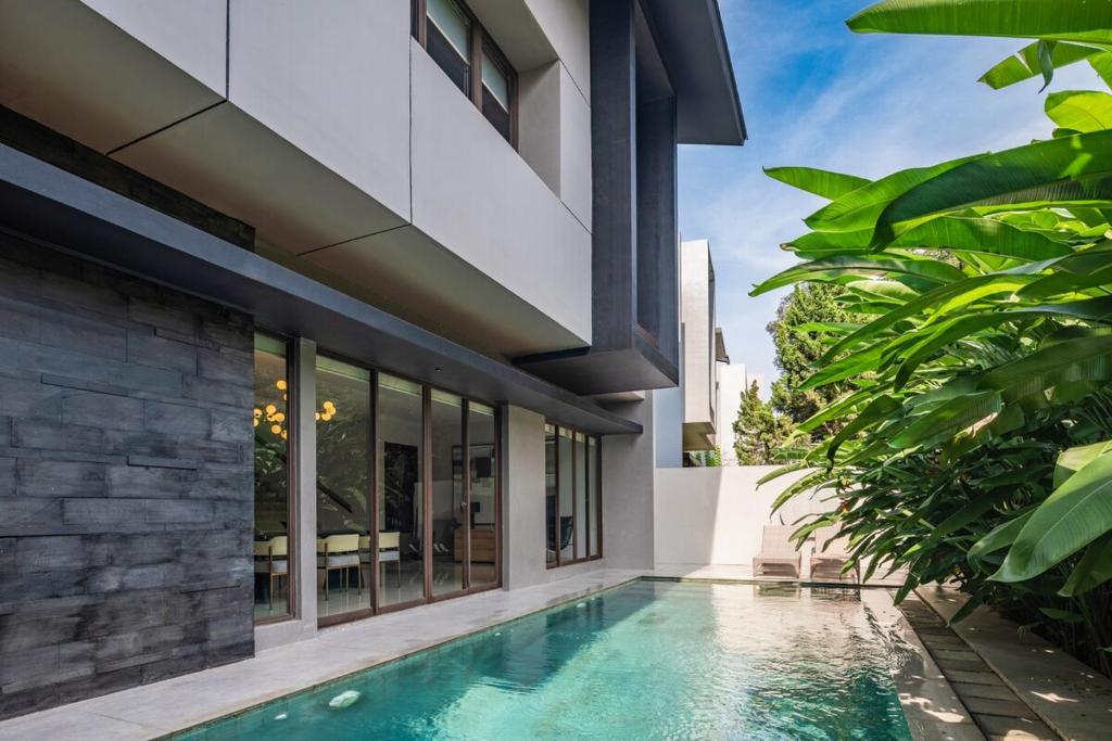 a swimming pool in front of a house at Your Luxury Villa in the South of Jakarta in Samporo